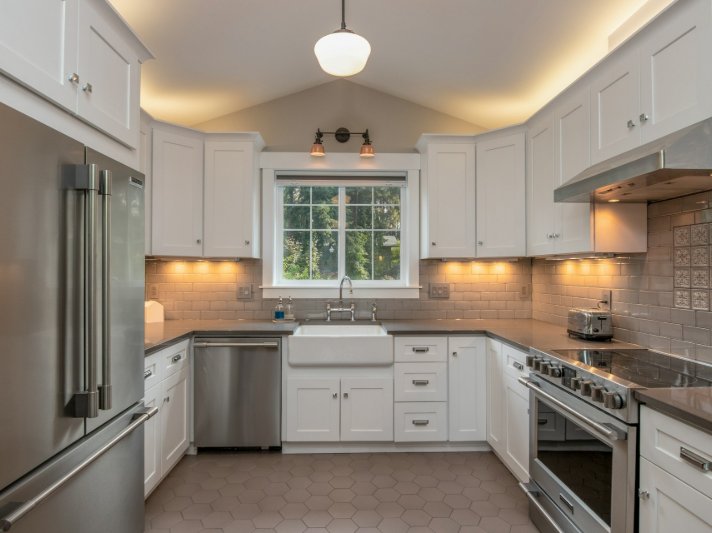Kitchen with white cabinets and beige tile
