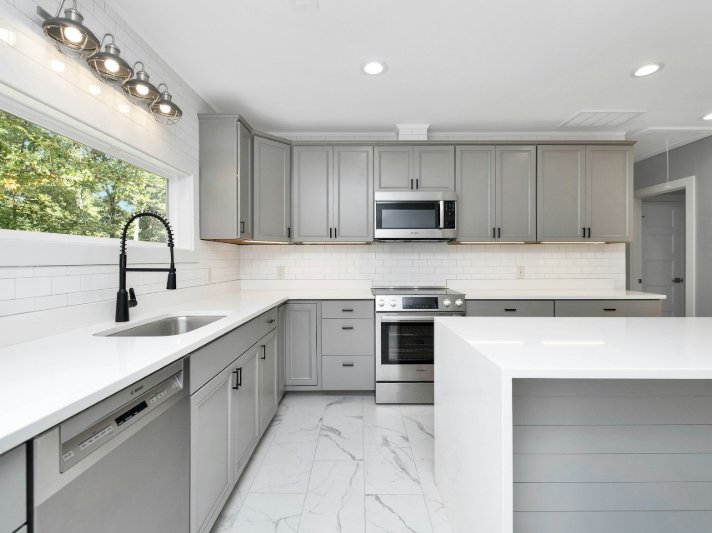 Kitchen with grey cabinets and white tile